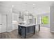 Beautiful kitchen island with modern pendant lighting and quartz countertops at 1101 Cooks Farm Way, Woodstock, GA 30189