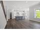 Open concept kitchen with gray island, stainless appliances, and hardwood floors at 1101 Cooks Farm Way, Woodstock, GA 30189