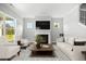 Bright living room with a fireplace, comfortable seating, and views of the backyard at 1101 Cooks Farm Way, Woodstock, GA 30189