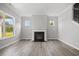 Bright living room features a fireplace, hardwood floors, and natural light at 1101 Cooks Farm Way, Woodstock, GA 30189