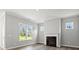 Bright living room features a fireplace, hardwood floors, and large windows at 1101 Cooks Farm Way, Woodstock, GA 30189