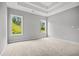 Spacious main bedroom with trey ceiling and large windows offering a view at 1101 Cooks Farm Way, Woodstock, GA 30189