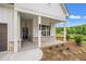 Inviting front porch with modern hanging lights and brick accents, adds to the curb appeal of this home at 1101 Cooks Farm Way, Woodstock, GA 30189