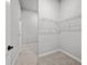 Spacious walk-in closet with neutral carpet and plenty of wire shelving at 1101 Cooks Farm Way, Woodstock, GA 30189