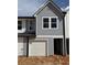 New construction home with a one-car garage and light-blue siding at 11618 E Lovejoy Rd, Hampton, GA 30228