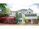 View of the home's backyard with a deck, large window, and mature landscaping at 1200 Larson Sw Ln, Marietta, GA 30064
