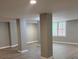 Finished basement space with modern gray flooring and support columns at 1200 Larson Sw Ln, Marietta, GA 30064