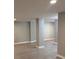 Finished basement space featuring modern gray flooring and support columns at 1200 Larson Sw Ln, Marietta, GA 30064