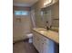 Bathroom boasts modern white tile shower and vanity with granite countertop at 1200 Larson Sw Ln, Marietta, GA 30064