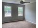 Bedroom with two windows and a ceiling fan providing comfort and brightness at 1200 Larson Sw Ln, Marietta, GA 30064