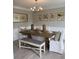 Elegant dining area with a large wooden table, upholstered chairs, and tasteful botanical wall art at 1200 Larson Sw Ln, Marietta, GA 30064