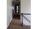 Hallway with neutral walls and carpeted floors, leading to various rooms with ample lighting at 1200 Larson Sw Ln, Marietta, GA 30064