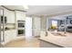 Bright kitchen features white cabinets, granite countertops, stainless steel appliances and an island sink at 1200 Larson Sw Ln, Marietta, GA 30064