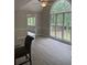 Bright living room with large arched windows and modern ceiling fan for optimal natural light and comfort at 1200 Larson Sw Ln, Marietta, GA 30064