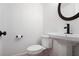Powder bathroom features modern fixtures, pedestal sink, black accents, and modern faucet at 136 Peachtree Memorial Nw Dr # Nj2, Atlanta, GA 30309