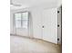 Bright bedroom with neutral carpet, white trim, and natural light from the large window at 136 Peachtree Memorial Nw Dr # Nj2, Atlanta, GA 30309