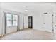 Bright bedroom with neutral carpet, white trim, and natural light from the large window at 136 Peachtree Memorial Nw Dr # Nj2, Atlanta, GA 30309