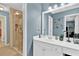 Bright bathroom featuring a glass enclosed shower, a large vanity, and ample lighting at 1477 Edenham Ln, Cumming, GA 30041