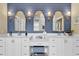 Bathroom featuring double vanity with lighted mirrors, shiplap accents and patterned tile floor at 1477 Edenham Ln, Cumming, GA 30041