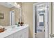 Bathroom featuring white vanity and sink, neutral walls, and a peek into the toilet and shower area at 1477 Edenham Ln, Cumming, GA 30041