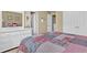 Comfortable bedroom boasts neutral carpeting, soft lighting, and a nicely made queen sized bed at 1477 Edenham Ln, Cumming, GA 30041