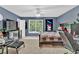 Comfortable bedroom featuring a ceiling fan, neutral carpet, and a large window providing natural light at 1477 Edenham Ln, Cumming, GA 30041