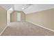 Large bonus room features neutral carpeting and paint; is well-lit with a ceiling fan at 1477 Edenham Ln, Cumming, GA 30041