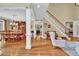 Dining area featuring hardwood floors and chandelier, seamlessly connected to the living spaces at 1477 Edenham Ln, Cumming, GA 30041