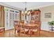 Elegant dining room with hardwood floors, classic furnishings, and bright windows with plantation shutters at 1477 Edenham Ln, Cumming, GA 30041