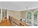 Bright foyer boasts hardwood floors, a chandelier and lots of natural light from an array of windows at 1477 Edenham Ln, Cumming, GA 30041