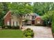 Charming two-story home with landscaped yard, driveway, and beautiful curb appeal at 1477 Edenham Ln, Cumming, GA 30041