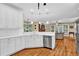 Bright kitchen featuring white cabinets, quartz countertops, stainless steel appliances and hardwood flooring at 1477 Edenham Ln, Cumming, GA 30041