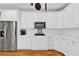 Bright kitchen with white cabinets, subway tile backsplash, and stainless steel appliances at 1477 Edenham Ln, Cumming, GA 30041