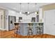 Modern kitchen featuring a center island with barstool seating, stainless steel appliances, and white cabinetry at 1477 Edenham Ln, Cumming, GA 30041