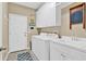 Laundry room featuring white appliances, sink, and cabinets at 1477 Edenham Ln, Cumming, GA 30041