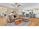 Open-concept living room with modern decor, hardwood flooring, and access to the kitchen at 1477 Edenham Ln, Cumming, GA 30041