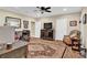 Inviting living room with hardwood floors, and a cozy atmosphere featuring an ornate area rug at 1477 Edenham Ln, Cumming, GA 30041