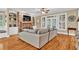 Inviting living room with a stone fireplace, beautiful hardwood floors, and views to the outside at 1477 Edenham Ln, Cumming, GA 30041
