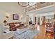 Open-concept living room with hardwood floors, a fireplace, and access to other living spaces at 1477 Edenham Ln, Cumming, GA 30041