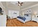 Main bedroom with vaulted ceiling, hardwood floors, and windows with white shutters at 1477 Edenham Ln, Cumming, GA 30041