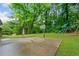 Backyard patio with basketball hoop and playground set surrounded by lush greenery at 1728 N Holly Ne Ln, Atlanta, GA 30329