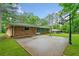 Backyard patio features a basketball hoop, umbrella, and a glimpse of the screened-in porch at 1728 N Holly Ne Ln, Atlanta, GA 30329
