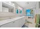 Bright bathroom with double vanity, tub with shower, and beach scene curtain at 1728 N Holly Ne Ln, Atlanta, GA 30329