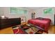 Bedroom with hardwood floors, dresser, and a colorful rug at 1728 N Holly Ne Ln, Atlanta, GA 30329