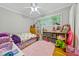 bedroom with hardwood floors, window, stuffed animals, and overhead lighting at 1728 N Holly Ne Ln, Atlanta, GA 30329