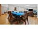 Dining room with hardwood flooring, skylights, and a view of the kitchen bar at 1728 N Holly Ne Ln, Atlanta, GA 30329