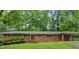 Charming single-story brick home with a well-maintained front yard and a covered carport at 1728 N Holly Ne Ln, Atlanta, GA 30329