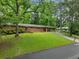 Lush greenery surrounds this brick home with a carport and well-manicured lawn at 1728 N Holly Ne Ln, Atlanta, GA 30329