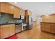 Spacious kitchen with stainless steel appliances, black countertops, wooden cabinets, and hardwood floors at 1728 N Holly Ne Ln, Atlanta, GA 30329