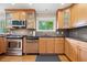 Bright kitchen features wooden cabinets, stainless steel appliances, and natural light from a window at 1728 N Holly Ne Ln, Atlanta, GA 30329